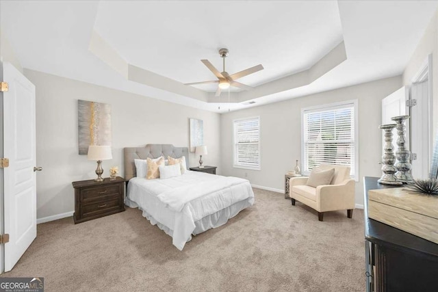 3607 Archgate Ct, Alpharetta, GA 30004 - bedroom featuring a tray ceiling, light carpet, and a ceiling fan