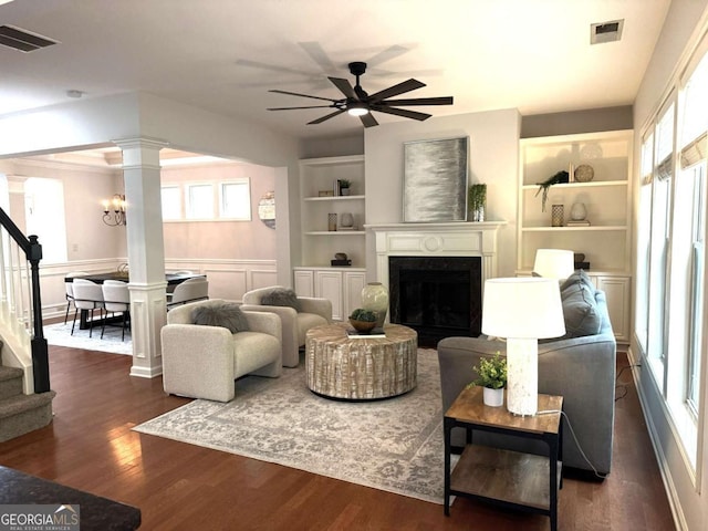 3607 Archgate Ct, Alpharetta, GA 30004 - living area with decorative columns, stairs, healthy amount of natural light, built in shelves, and wainscoting