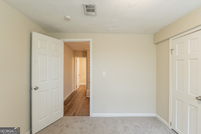 4669 Birch Ridge Trl, Stone Mountain, GA 30083 - unfurnished bedroom featuring carpet flooring and a textured ceiling