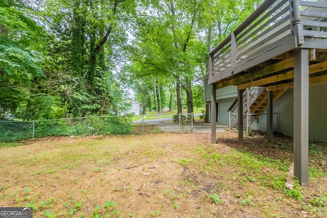 4669 Birch Ridge Trl, Stone Mountain, GA 30083 - view of yard featuring a wooden deck, stairs, and an attached garage