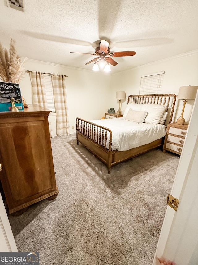 507 S College St, Metter, GA 30439 - carpeted bedroom featuring a textured ceiling, ornamental molding, and a ceiling fan