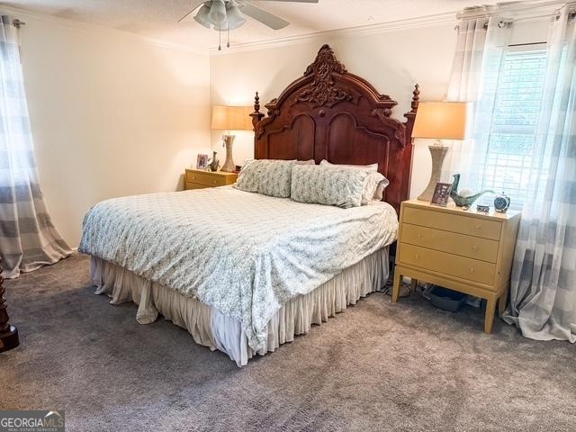 507 S College St, Metter, GA 30439 - carpeted bedroom featuring crown molding and a ceiling fan