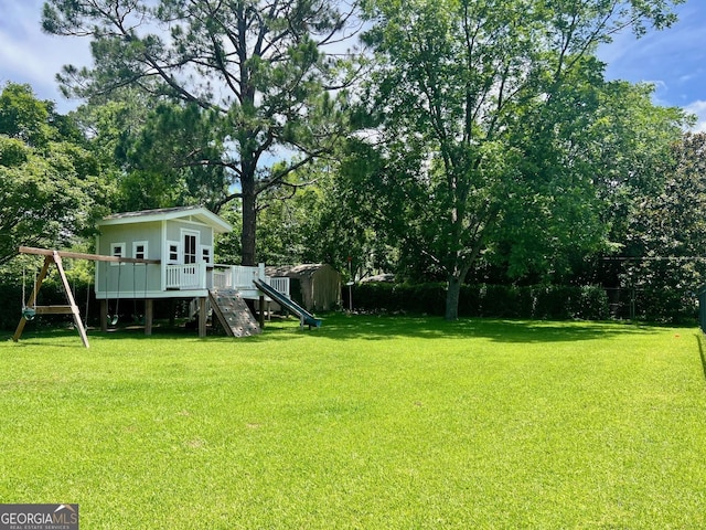 507 S College St, Metter, GA 30439 - view of grassy yard with a playground, a wooden deck, and stairway