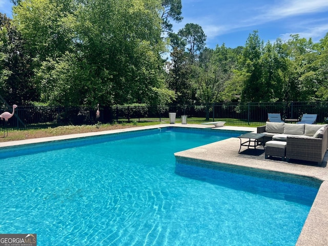 507 S College St, Metter, GA 30439 - view of pool featuring a fenced backyard, view of scattered trees, and a diving board