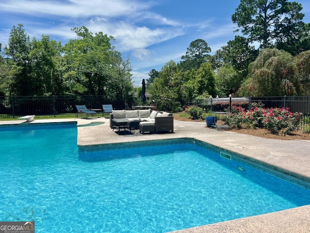 507 S College St, Metter, GA 30439 - view of pool with outdoor lounge area, a patio area, a fenced backyard, and view of wooded area