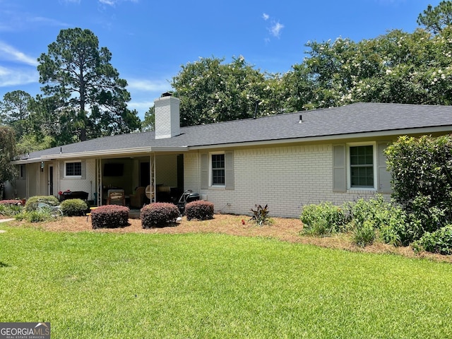 507 S College St, Metter, GA 30439 - rear view of property with brick siding, a yard, a chimney, and roof with shingles