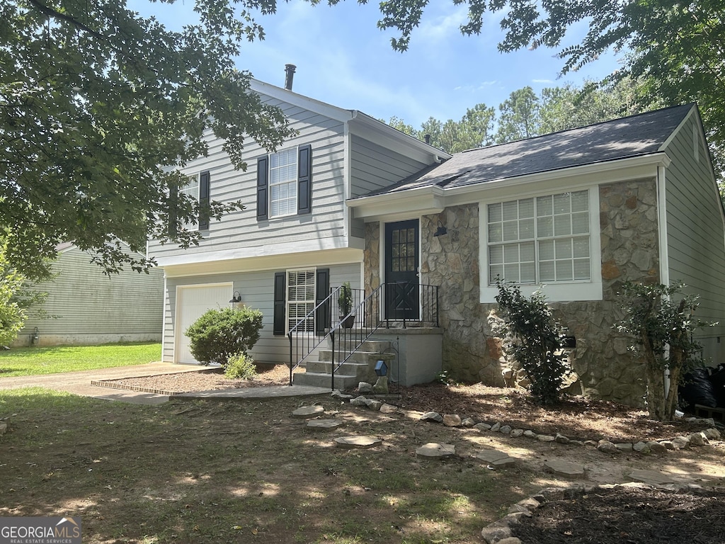 4164 River Shoals Ct, Duluth, GA 30097 - split level home with stone siding, driveway, and an attached garage