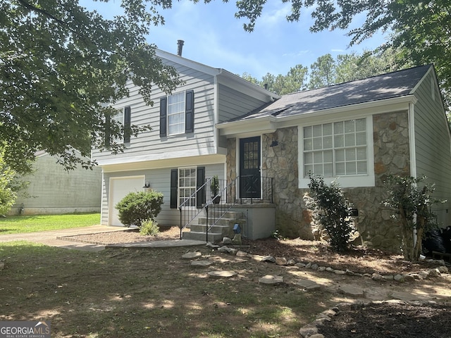 4164 River Shoals Ct, Duluth, GA 30097 - split level home with stone siding, driveway, and an attached garage