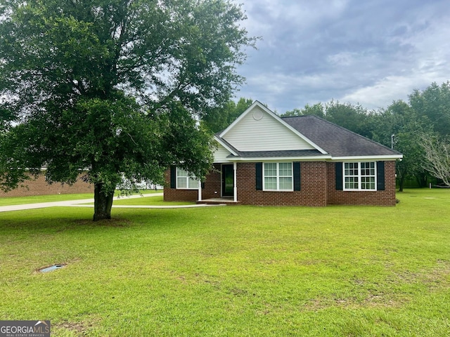 317 S Terrell St, Metter, GA 30439 - ranch-style house with a front yard and brick siding