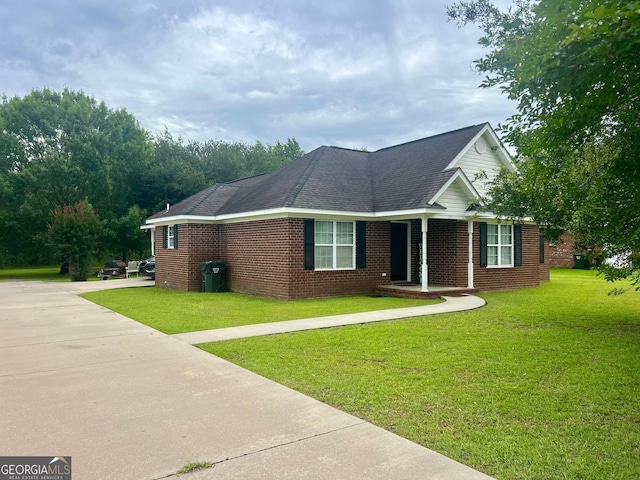 317 S Terrell St, Metter, GA 30439 - single story home with a front yard, concrete driveway, and brick siding