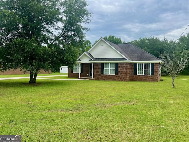 317 S Terrell St, Metter, GA 30439 - ranch-style home with a front yard, brick siding, and a shingled roof