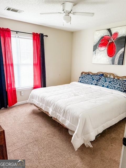 317 S Terrell St, Metter, GA 30439 - bedroom with carpet, baseboards, and a ceiling fan
