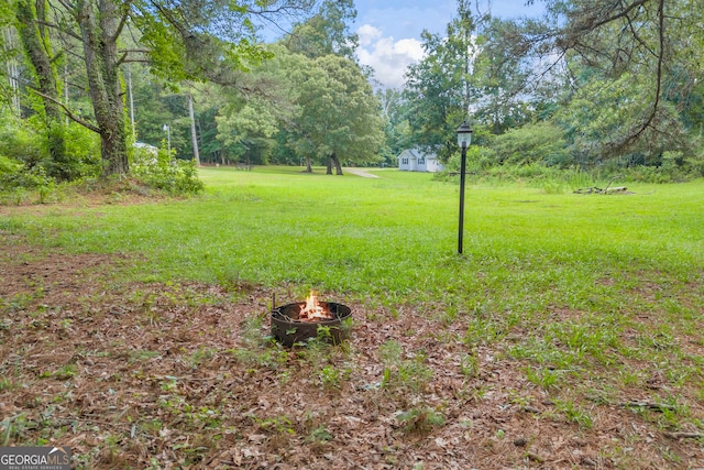 676 Smith Store Rd, Covington, GA 30016 - view of grassy yard with an outdoor fire pit