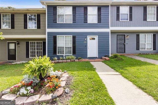 8566 Jamestown Way, Jonesboro, GA 30238 - townhome / multi-family property featuring a front yard