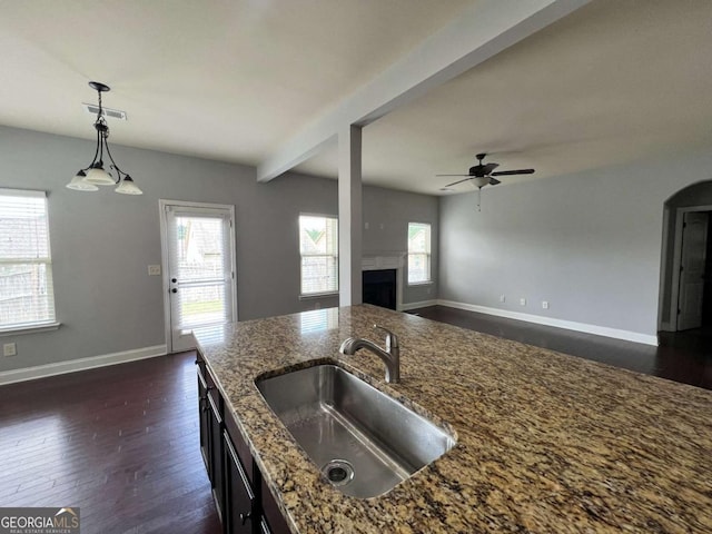 3522 Fallen Oak Dr, Buford, GA 30519 - kitchen featuring a sink, ceiling fan, dark wood-style floors, dark stone countertops, and beamed ceiling