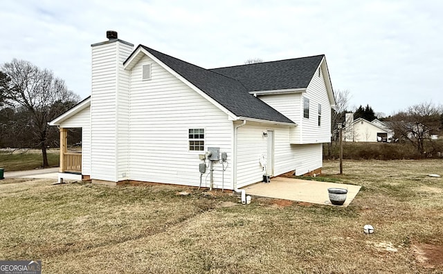 110 Waterloo Dr, Mount Airy, GA 30563 - view of home's exterior featuring a shingled roof, a chimney, a yard, and a patio