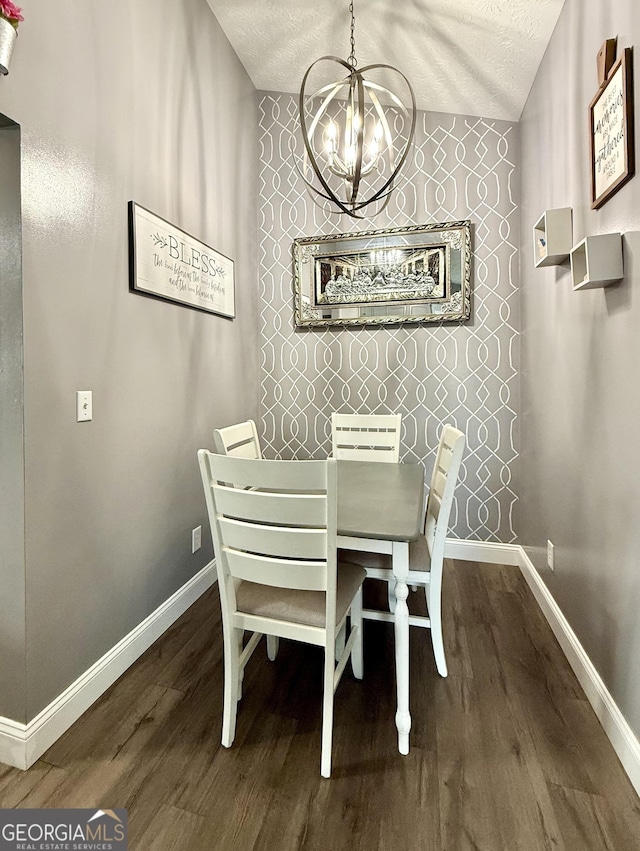 110 Waterloo Dr, Mount Airy, GA 30563 - dining area with a chandelier, a textured ceiling, wood finished floors, and an accent wall