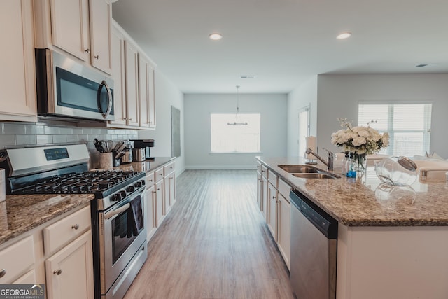 82 Castlemoor Loop, Adairsville, GA 30103 - kitchen with appliances with stainless steel finishes, light wood finished floors, tasteful backsplash, light stone counters, and recessed lighting