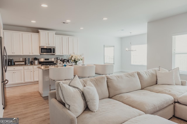 82 Castlemoor Loop, Adairsville, GA 30103 - living area featuring light wood-type flooring, recessed lighting, plenty of natural light, and a chandelier