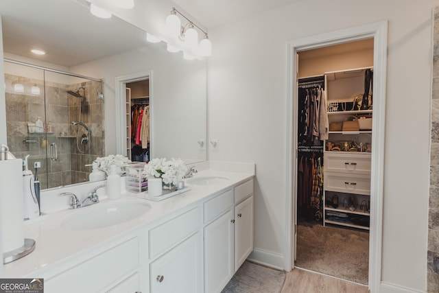 82 Castlemoor Loop, Adairsville, GA 30103 - full bathroom with double vanity, a walk in closet, and a shower stall