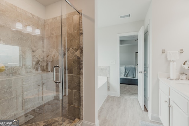82 Castlemoor Loop, Adairsville, GA 30103 - full bathroom featuring ensuite bathroom, vanity, a shower stall, wood finished floors, and a tub