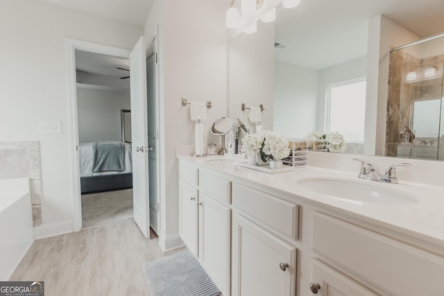 82 Castlemoor Loop, Adairsville, GA 30103 - full bathroom with double vanity, a bath, wood finished floors, a tile shower, and ensuite bath