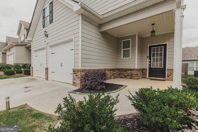 82 Castlemoor Loop, Adairsville, GA 30103 - doorway to property featuring a garage, brick siding, and concrete driveway