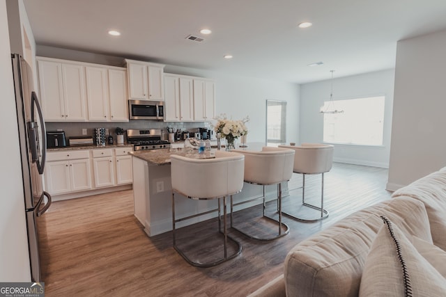 82 Castlemoor Loop, Adairsville, GA 30103 - kitchen with stainless steel appliances, decorative backsplash, light wood finished floors, white cabinetry, and recessed lighting