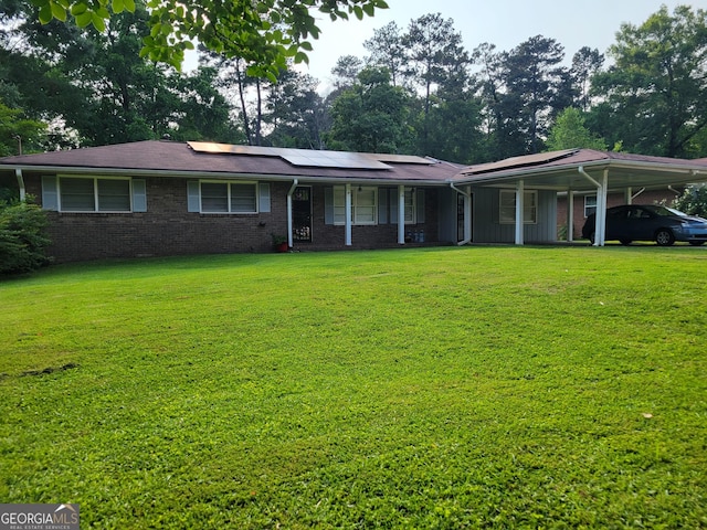 4157 Cedar Valley Ln, Conley, GA 30288 - single story home with a porch, a front yard, roof mounted solar panels, brick siding, and an attached carport