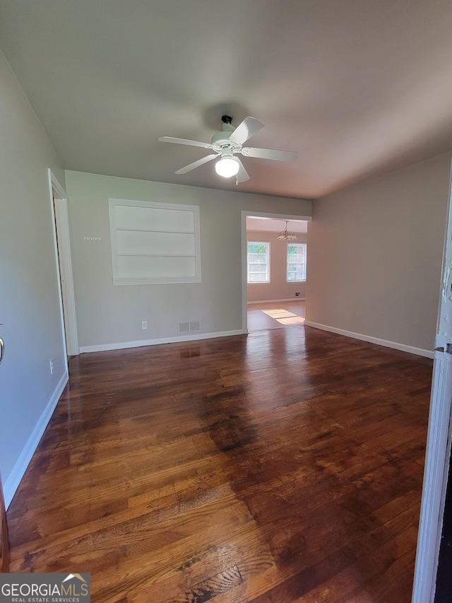 4157 Cedar Valley Ln, Conley, GA 30288 - spare room with ceiling fan, wood finished floors, baseboards, and a chandelier