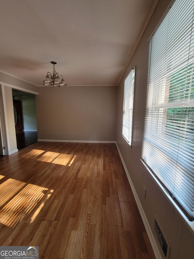 4157 Cedar Valley Ln, Conley, GA 30288 - spare room with a chandelier, dark wood-type flooring, baseboards, and ornamental molding