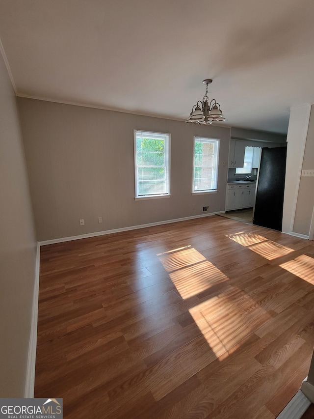 4157 Cedar Valley Ln, Conley, GA 30288 - unfurnished dining area featuring a chandelier, wood finished floors, baseboards, and ornamental molding