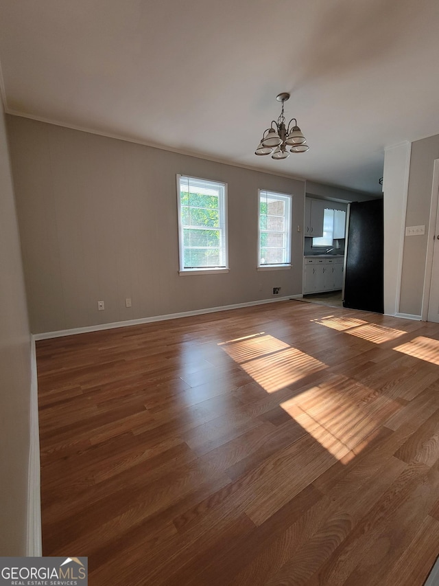 4157 Cedar Valley Ln, Conley, GA 30288 - unfurnished living room featuring a chandelier, wood finished floors, and baseboards