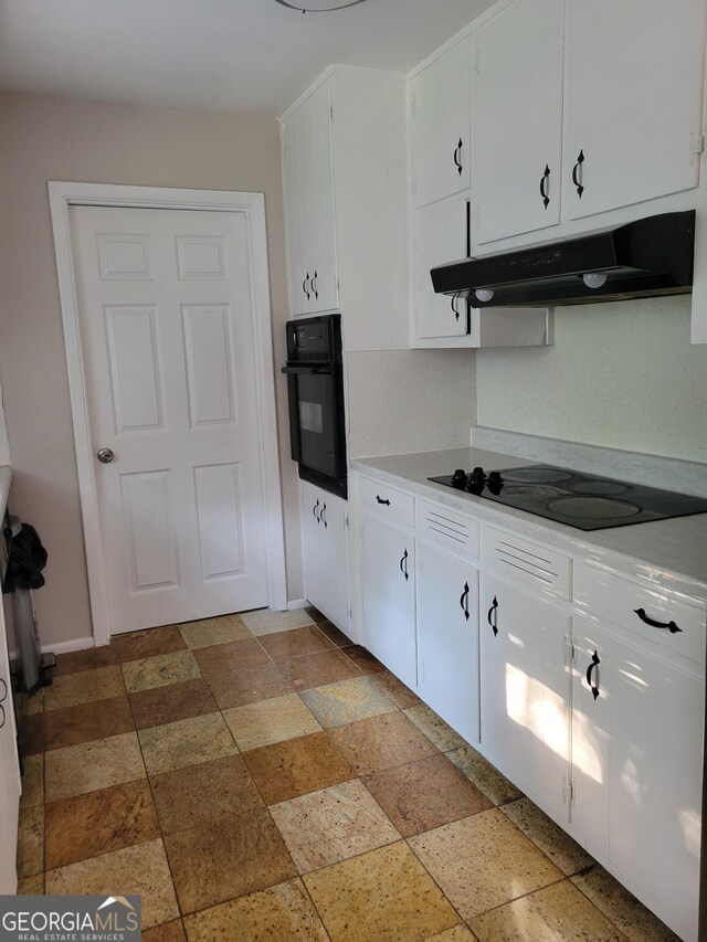 4157 Cedar Valley Ln, Conley, GA 30288 - kitchen featuring black appliances, under cabinet range hood, white cabinetry, and light countertops