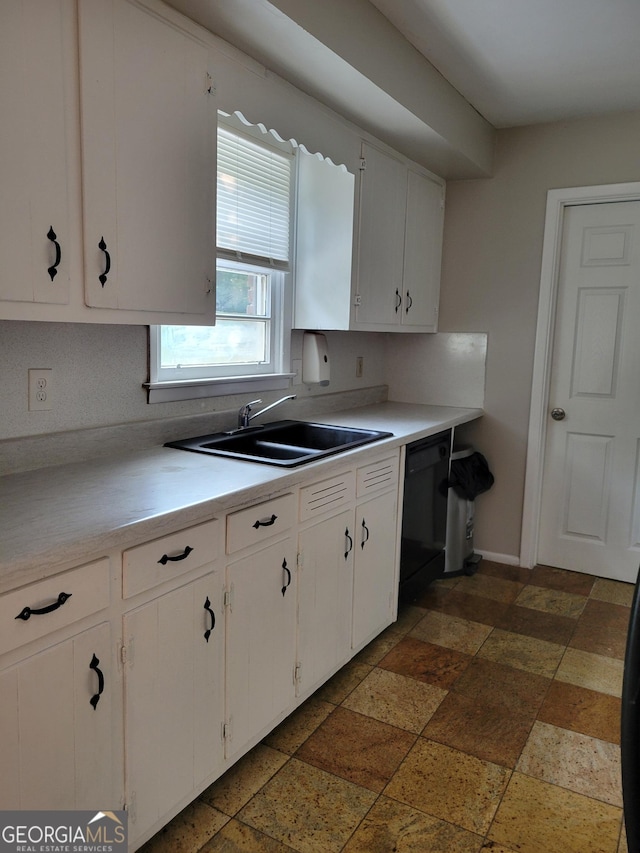 4157 Cedar Valley Ln, Conley, GA 30288 - kitchen featuring a sink, black dishwasher, light countertops, white cabinets, and stone tile floors