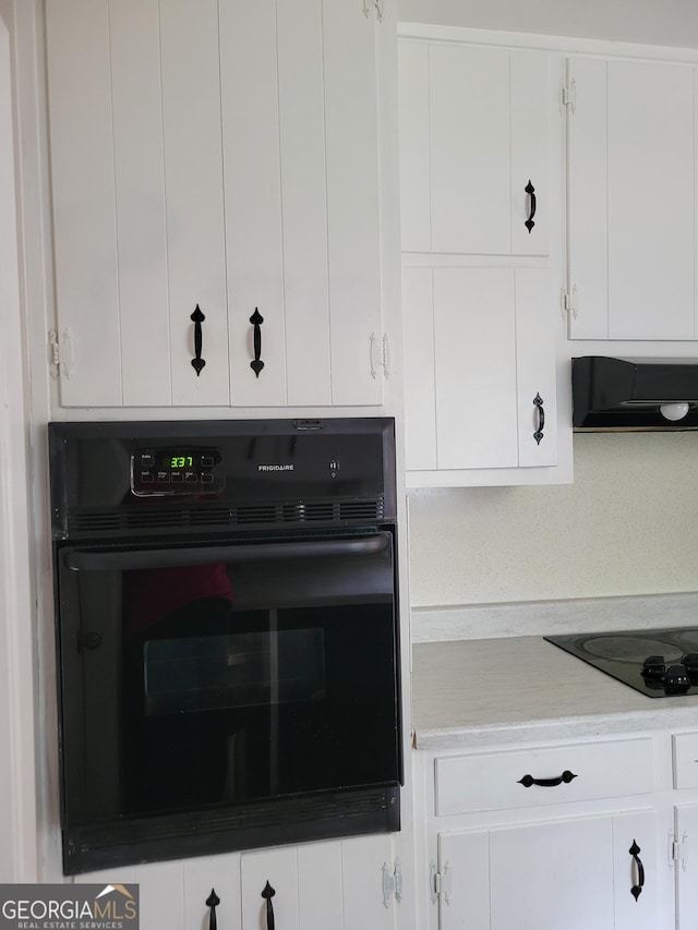 4157 Cedar Valley Ln, Conley, GA 30288 - kitchen with extractor fan, black appliances, white cabinets, and light countertops