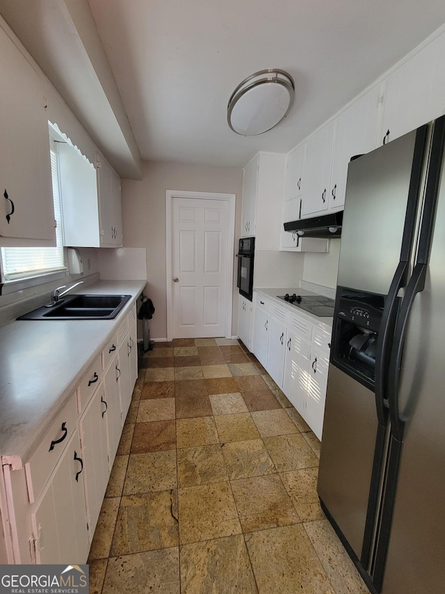 4157 Cedar Valley Ln, Conley, GA 30288 - kitchen with black appliances, a sink, stone tile floors, under cabinet range hood, and light countertops