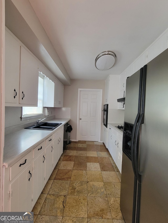 4157 Cedar Valley Ln, Conley, GA 30288 - kitchen featuring black appliances, stone tile floors, light countertops, white cabinets, and a sink