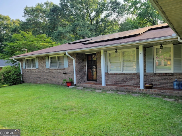 4157 Cedar Valley Ln, Conley, GA 30288 - ranch-style home featuring a front lawn, solar panels, brick siding, and a porch