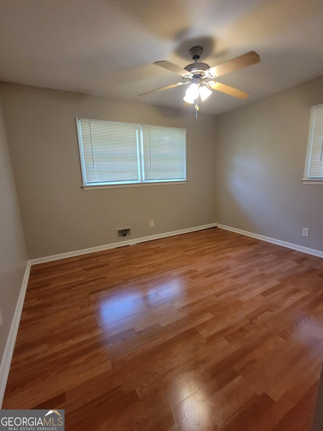 4157 Cedar Valley Ln, Conley, GA 30288 - unfurnished room featuring wood finished floors, a ceiling fan, and baseboards