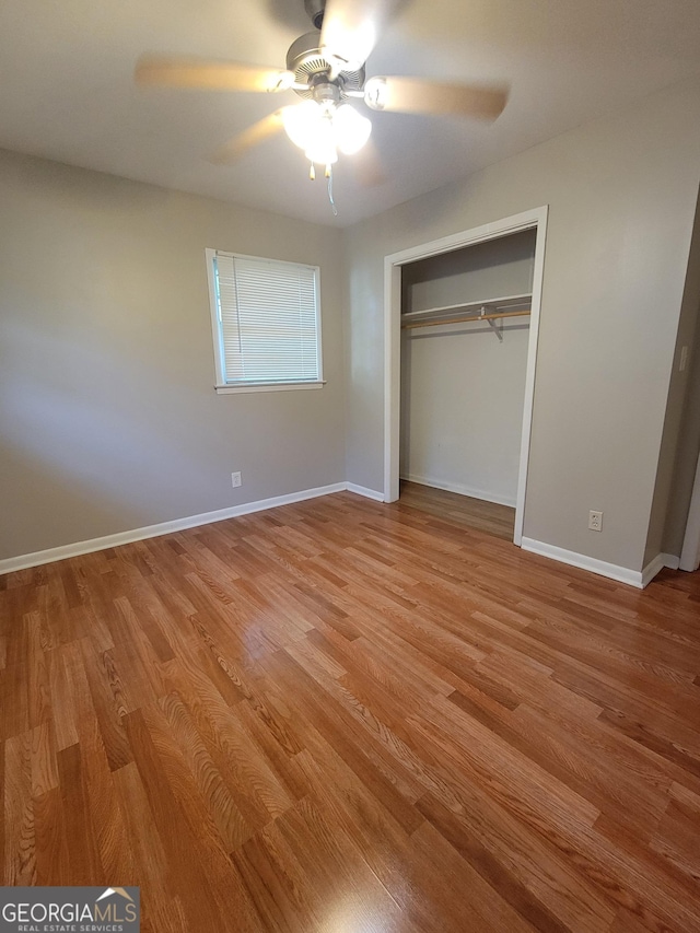 4157 Cedar Valley Ln, Conley, GA 30288 - unfurnished bedroom featuring light wood finished floors, baseboards, a closet, and a ceiling fan