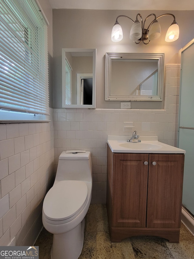 4157 Cedar Valley Ln, Conley, GA 30288 - bathroom featuring tile walls, vanity, toilet, wainscoting, and a shower with door