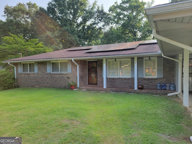 4157 Cedar Valley Ln, Conley, GA 30288 - view of front of home with a front yard, roof mounted solar panels, covered porch, and brick siding