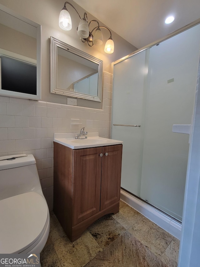4157 Cedar Valley Ln, Conley, GA 30288 - bathroom featuring a stall shower, vanity, toilet, and tile walls