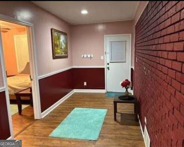 4157 Cedar Valley Ln, Conley, GA 30288 - corridor featuring wood finished floors, brick wall, and baseboards