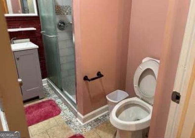 4157 Cedar Valley Ln, Conley, GA 30288 - bathroom featuring a stall shower, toilet, and tile patterned flooring
