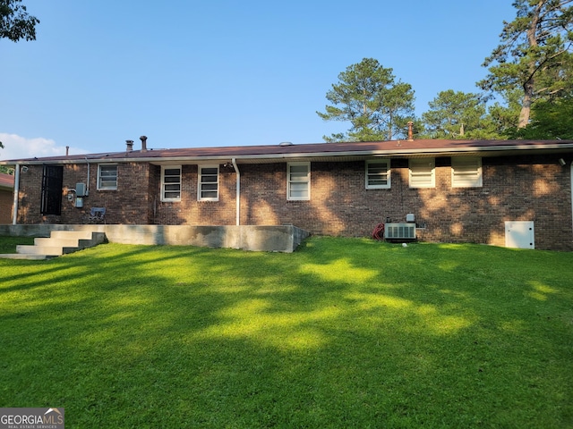 4157 Cedar Valley Ln, Conley, GA 30288 - rear view of property featuring central AC unit, brick siding, and a yard