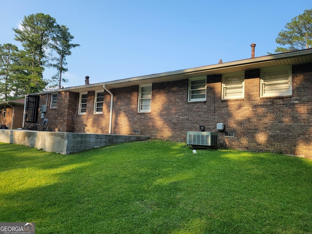 4157 Cedar Valley Ln, Conley, GA 30288 - rear view of property with central AC, a lawn, brick siding, and crawl space
