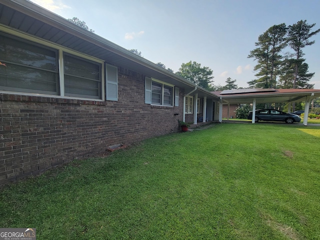 4157 Cedar Valley Ln, Conley, GA 30288 - view of home's exterior with a yard, a carport, and brick siding