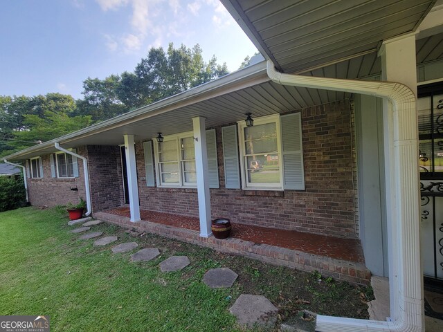 4157 Cedar Valley Ln, Conley, GA 30288 - property entrance with brick siding, covered porch, and a yard